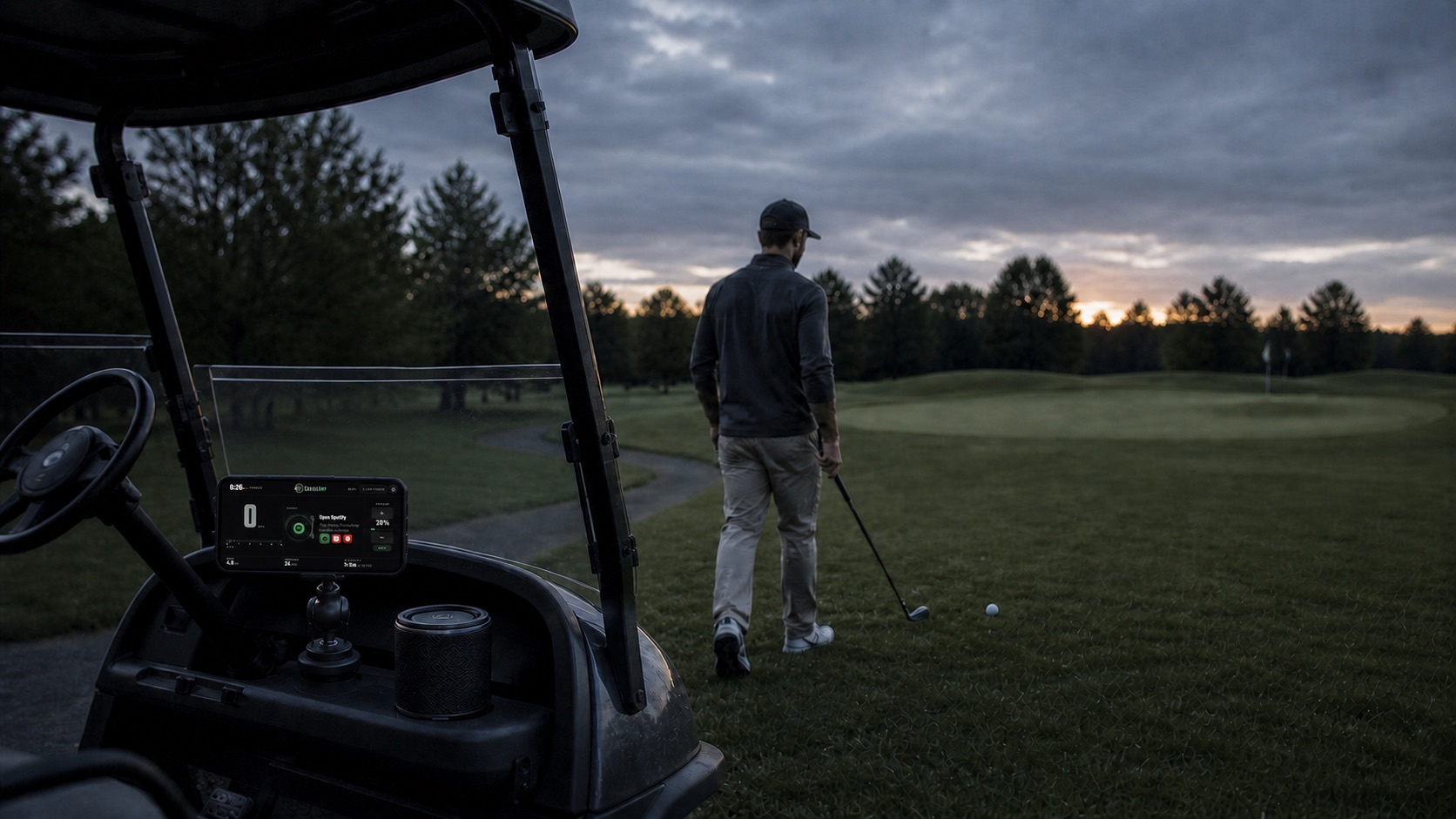A golfer walks toward a ball while CruiseAmp runs on a phone mounted beside the golf cart's Bluetooth speaker