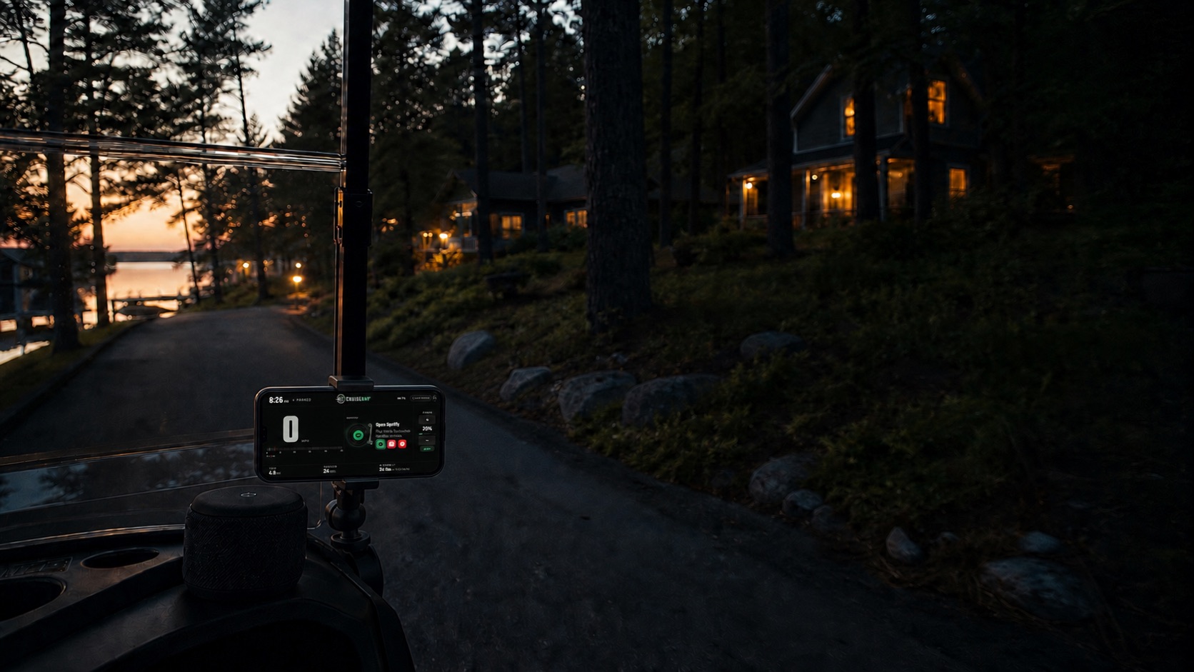 CruiseAmp runs on a phone mounted above a Bluetooth speaker in a neighborhood cart at dusk