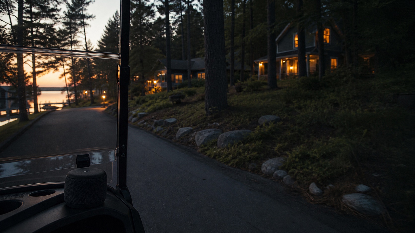 A Bluetooth speaker rides in a neighborhood cart at dusk near the lake