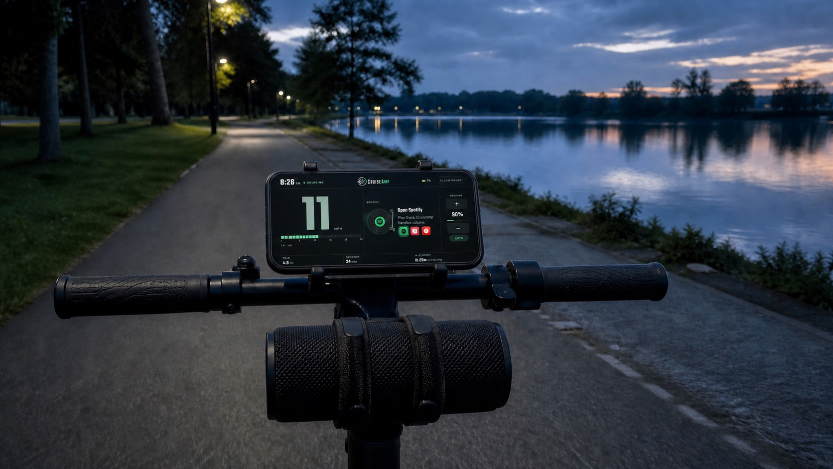 CruiseAmp runs on a securely mounted phone above a Bluetooth speaker on a scooter beside a lake at blue hour